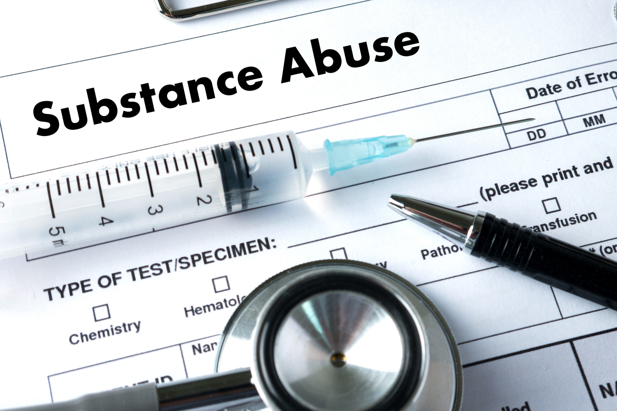 Syringe and stethoscope on substance abuse form