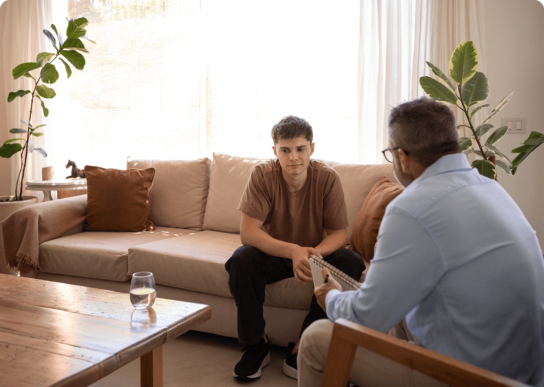 Two people discussing on a couch