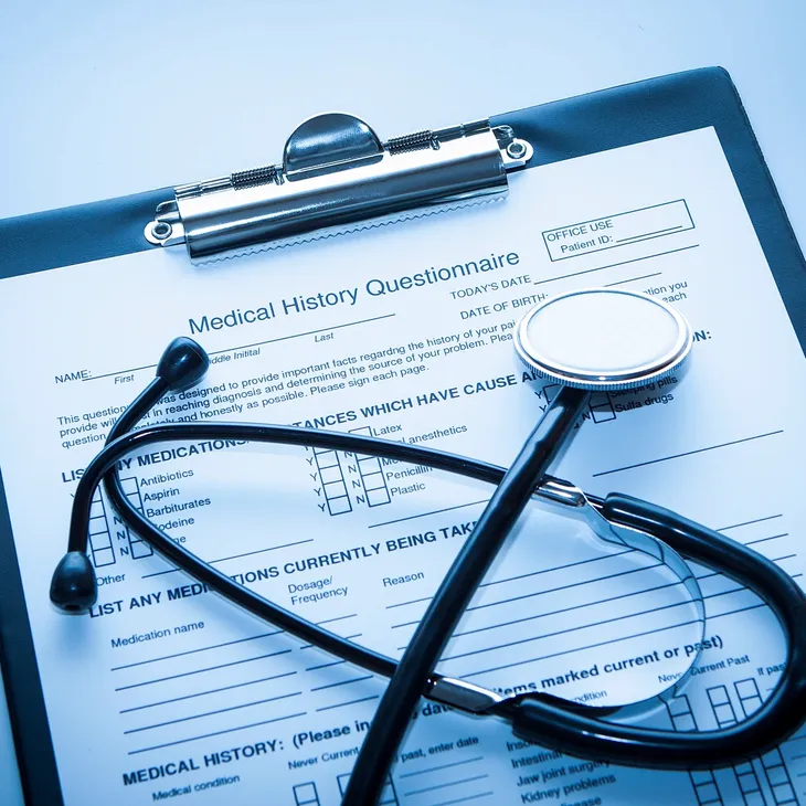 Medical history questionnaire with stethoscope on clipboard
