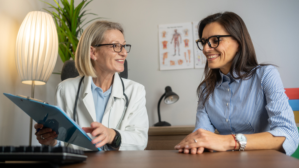 Doctor and patient smiling during clinic consultation