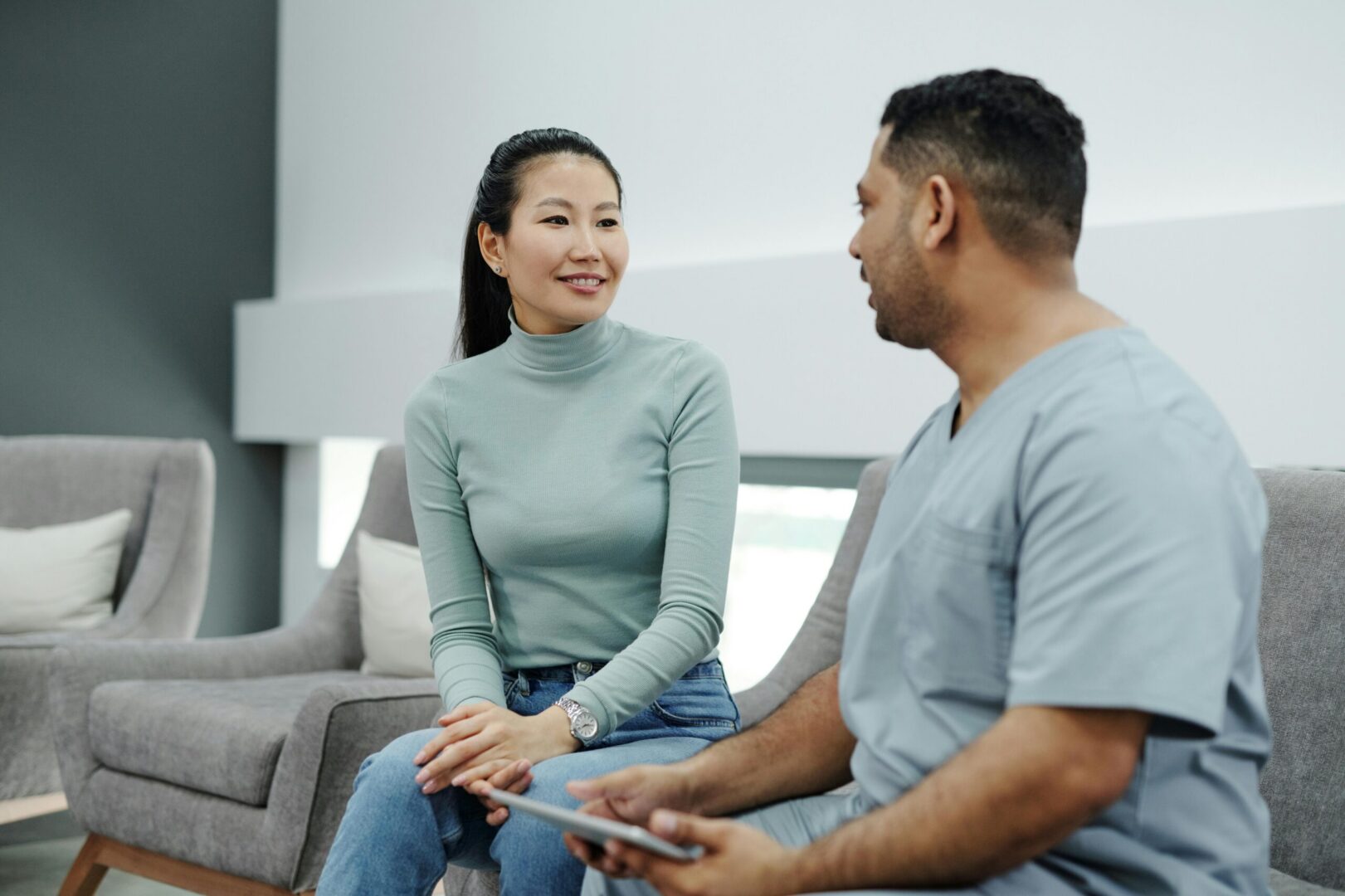 Woman speaking with medical professional in clinic