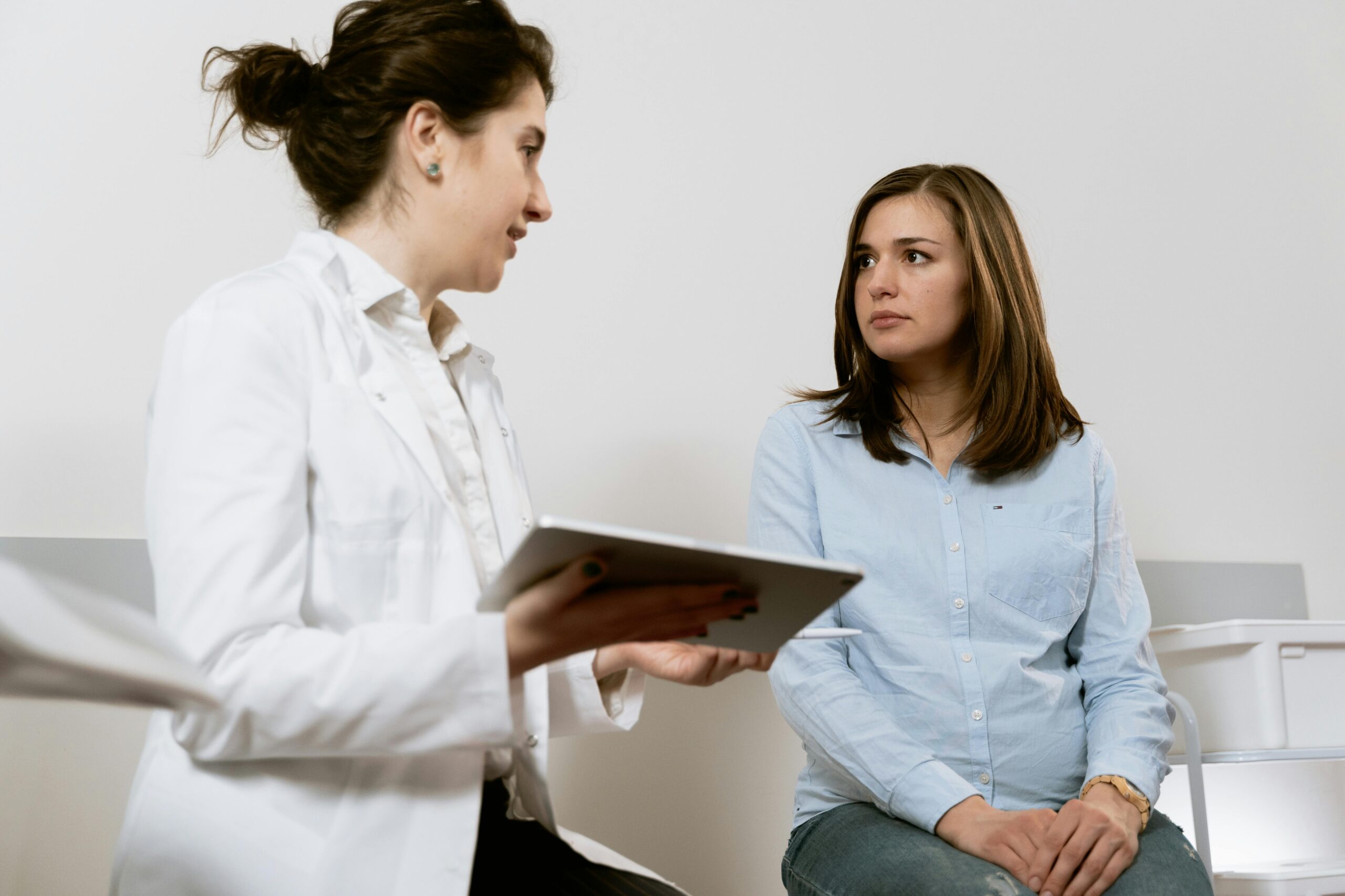 Doctor consulting patient in exam room