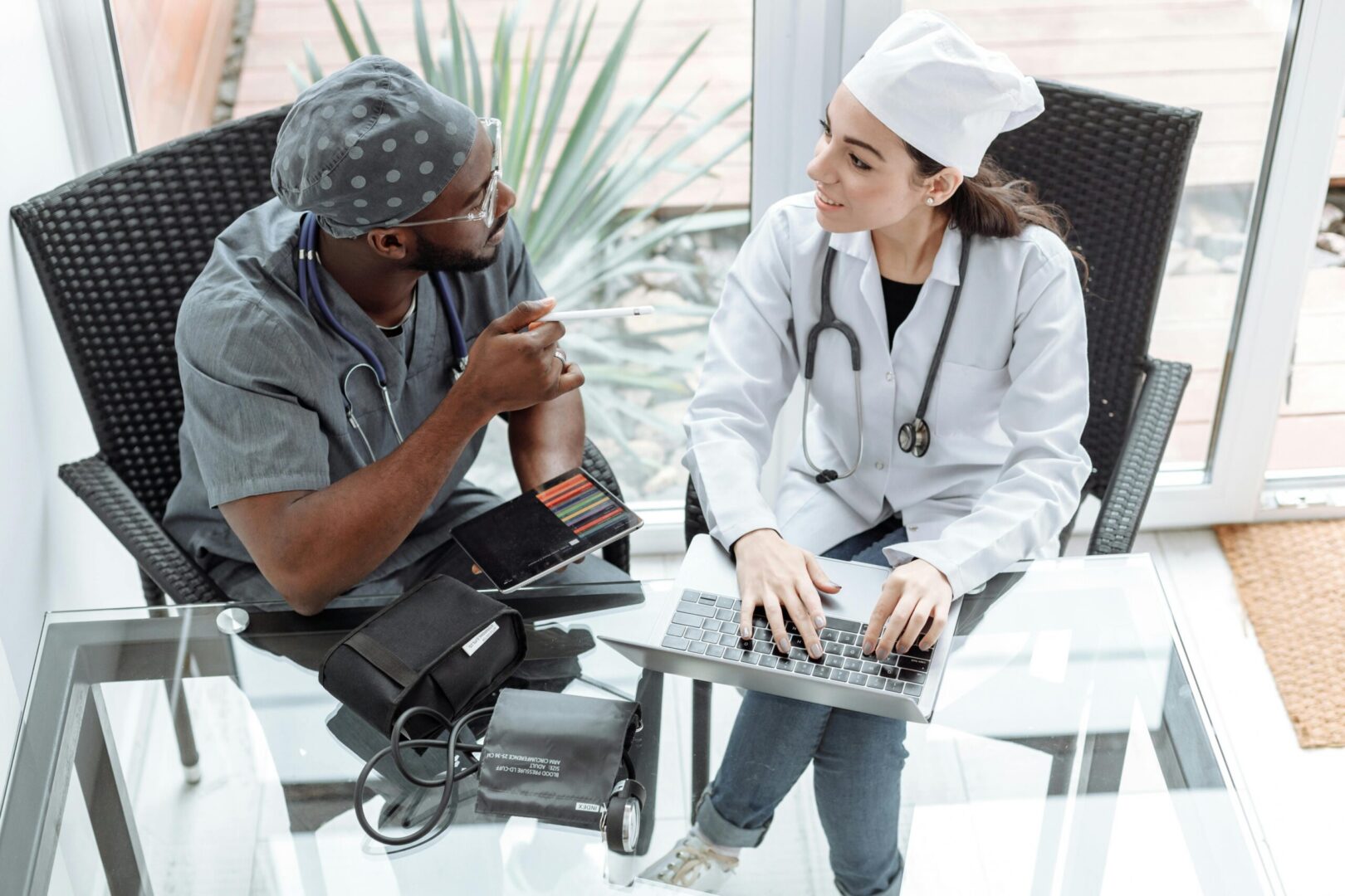 Medical professionals reviewing patient data on laptop