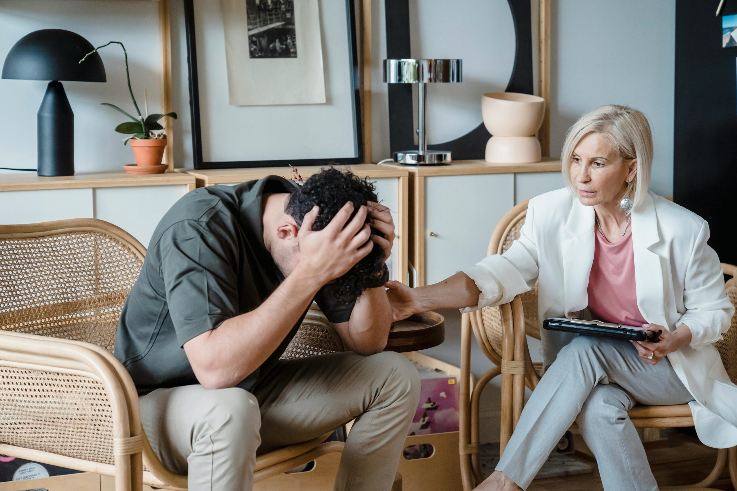 Therapist comforting distressed man during counseling