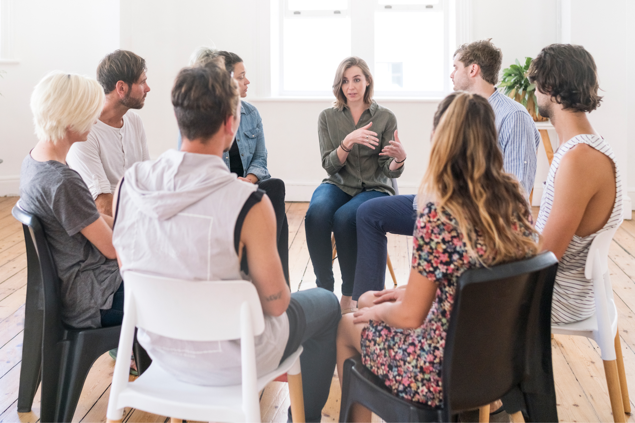 Group therapy session with facilitator speaking