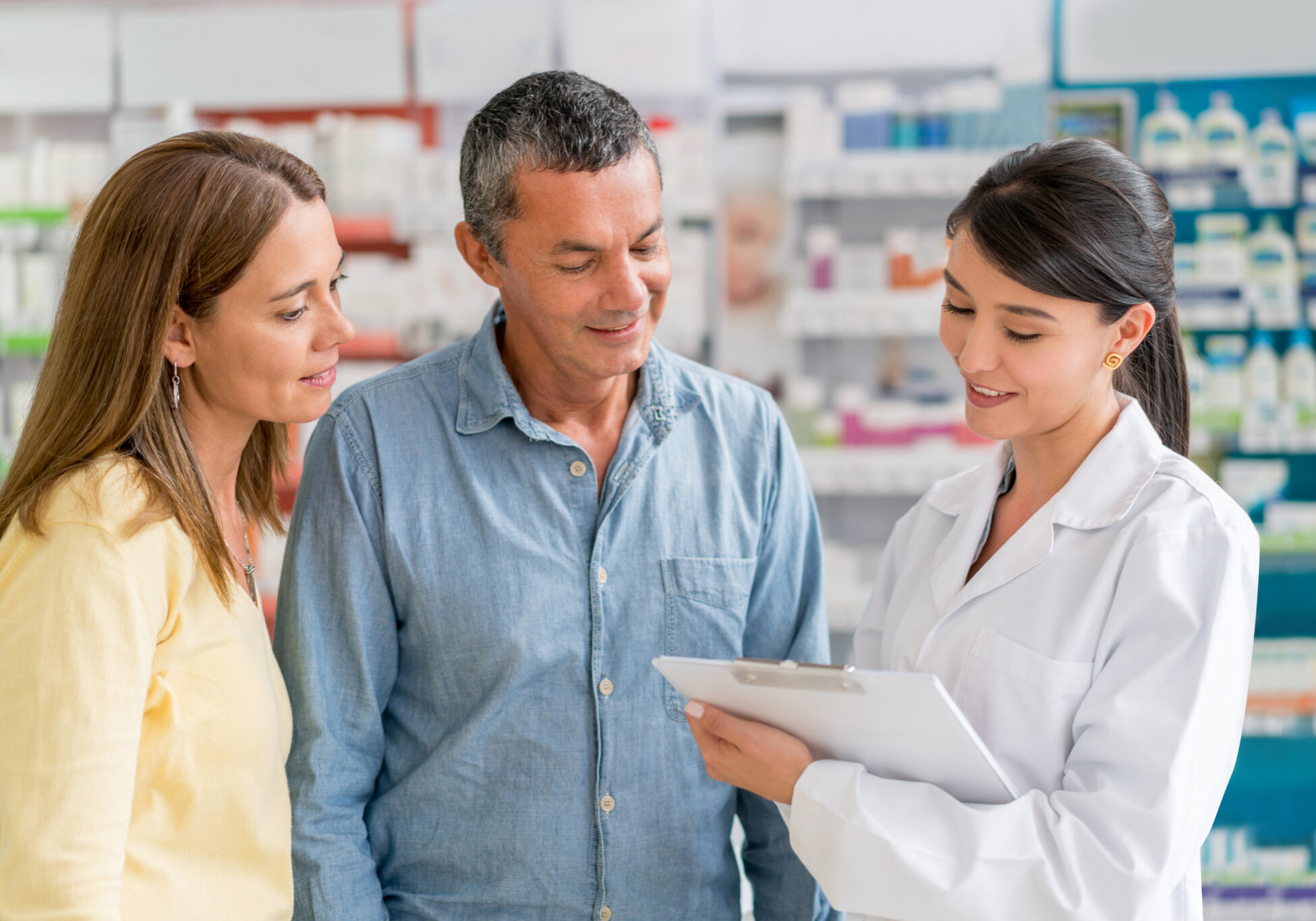 Pharmacist advising couple about medications